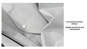 Detailed close-up of light gray woven jacket featuring a silver snap button and black zipper