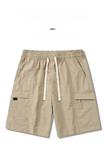 Detailed flat lay of khaki cargo shorts with elastic drawstring waist and side pockets