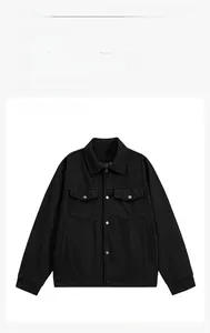 Detail of black corduroy jacket showing texture, snap buttons and utility chest pockets