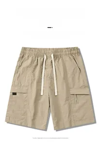 Macro view of khaki cargo shorts showing elastic waistband and drawstring details
