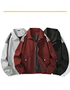 Detail of ribbed cuffs and shoulder stripes on folded gray, red and black jackets