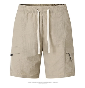 Detail of khaki cargo shorts showing elastic waist with white drawstrings and side pockets