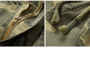 Detail of bronze metal zipper and drawstring on vintage camouflage cargo shorts