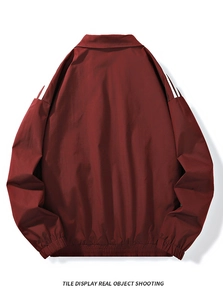 Detail of dark red casual jacket back view with white stripes and elastic cuffs