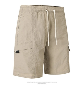 Detail of khaki cargo shorts showing elastic drawstring waist and large utility pocket