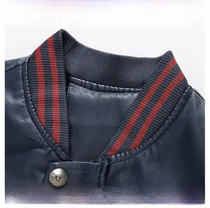 Detail display of striped knit ribbed collar and metal snap button on blue PU jacket