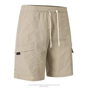 Close-up of khaki cargo shorts showing elastic drawstring waist and side pocket details