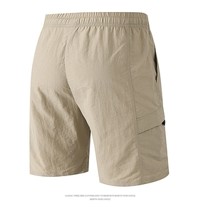 Detail view of khaki cargo shorts showing elastic waist and durable side pocket
