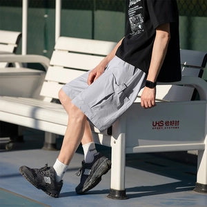 Men's light gray cargo shorts with large side pockets for summer outdoor activities