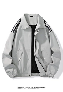 Close-up of light gray men's jacket featuring black shoulder stripes and a lapel collar
