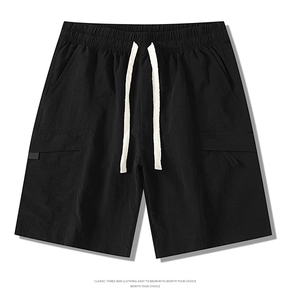 Detailed view of black cargo shorts with elastic waist and white contrast drawstrings