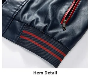 Detail of navy PU leather jacket hem with red stripe ribbing and metal zipper pocket