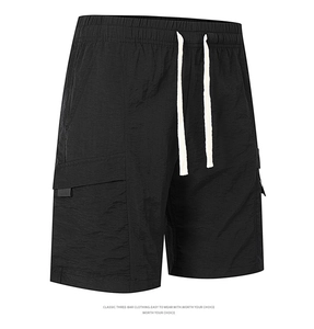 Detail view of black cargo shorts featuring elastic drawstring waist and side patch pockets