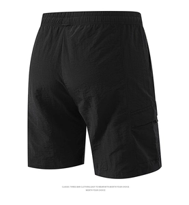 Close-up of the elastic waistband and textured fabric on black cargo shorts back
