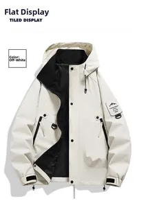 Detail view of off-white outdoor jacket with functional zippers and mountain sleeve patch