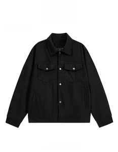 Detail of vintage black corduroy jacket showing fine texture, lapel and buttoned chest pockets