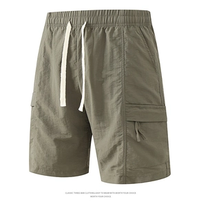 Detail of olive green cargo shorts featuring elastic waist with white drawstrings and pockets