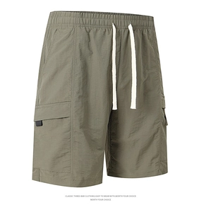 Close-up of olive green cargo shorts featuring elastic waistband and drawstring detail