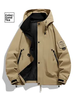 Detail of sand brown hooded jacket showing outdoor cargo pockets and embroidered sleeve patch