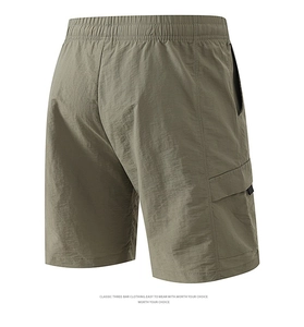 Detail of olive green cargo shorts featuring elastic waistband and large back pocket