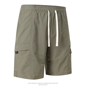 Detail of army green cargo shorts featuring elastic waistband and white drawstring