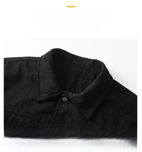 Detail of a corduroy jacket collar with a matte button and thick vertical texture