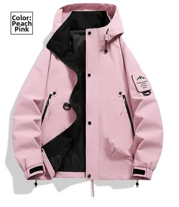 Close-up of peach pink outdoor jacket detail featuring mountain logo patch and velcro cuff