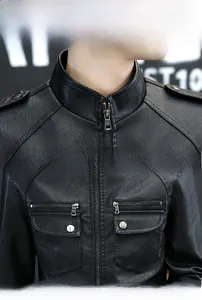 Detail view of black motorcycle leather jacket collar, metal zippers, and shoulder straps