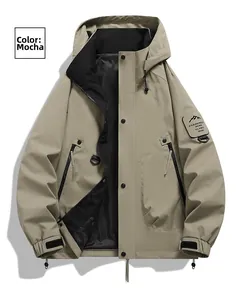 Detail of mocha outdoor jacket featuring adjustable hood and sleeve mountain patch