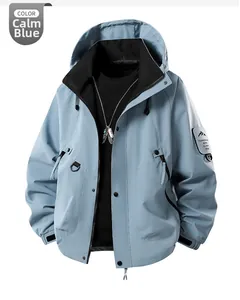Detail of Quiet Blue outdoor windbreaker featuring mountain patch and drawstring hood