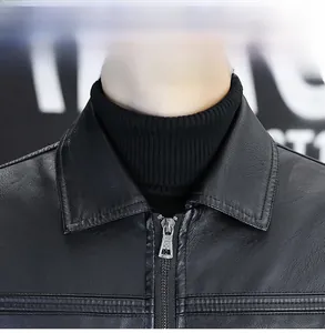 Detailed view of the black faux leather jacket collar and smooth metal zipper texture