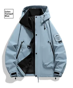 Detail of Quiet Blue windbreaker jacket featuring hooded collar and branded arm patch