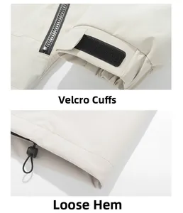 Detail view of adjustable velcro cuffs and drawstring hem on off-white outdoor jacket