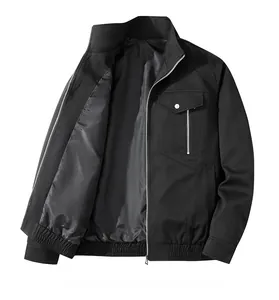 Detail of a black standing collar jacket featuring a metallic zip pocket and snap button