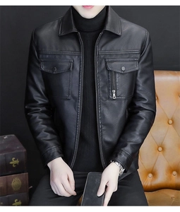 Detail of black faux leather motorcycle jacket with lapel collar and metal zip pockets