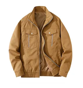 Detail of tan stand collar jacket featuring front flap pockets and vertical zippers