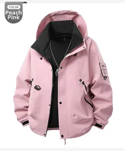 Detail view of pink hooded windbreaker with adjustable cuffs and mountain arm patch