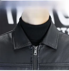 Detail view of classic lapel collar and metal zipper on black faux leather jacket