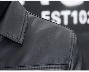 Detailed close-up showing the shoulder stitching and collar texture of the black leather jacket