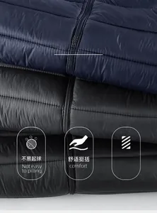 Detail of quilted texture showing soft navy, grey, and black thermal puffer fabric