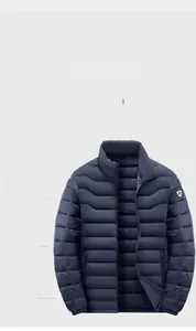 Detail of navy blue quilted winter jacket showing circular sleeve patch and zipper