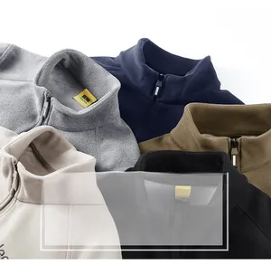 Close-up of multicolored polar fleece jackets featuring half-zip stand collars and soft texture