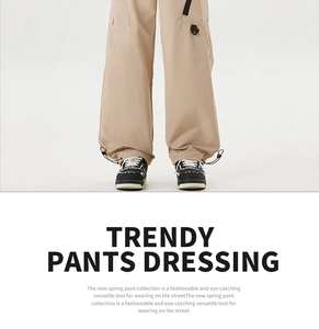 Detail view of khaki cargo pants featuring adjustable drawstring cuffs and large side pockets