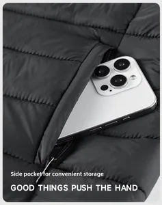 Detail of the hidden zippered side pocket on black quilted winter jacket with phone
