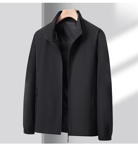 Detail of a men's black stand-collar windbreaker jacket with premium zipper and smooth texture