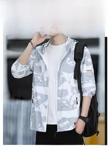 Detail of men's UV protection jacket with grey camo pattern and wrist logo detail