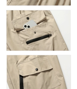 Detail of light khaki cargo pants featuring ripstop texture and zip utility pocket