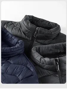 Macro shot showing zippers and fabric detail of quilted vests in black, navy, and grey