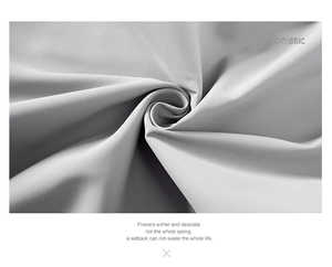 Macro shot of light gray fabric texture showing soft weave and detailed fiber quality
