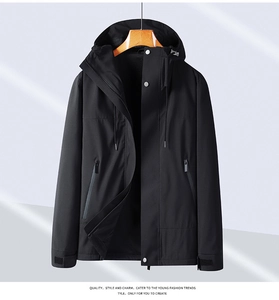 Detail of waterproof zipper pockets and windproof velcro cuffs on black outdoor jacket